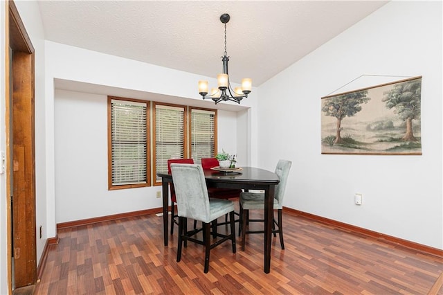 4065 Maxanne Dr NW, Kennesaw, GA 30144 - dining area featuring dark wood-type flooring, baseboards, a textured ceiling, and a notable chandelier