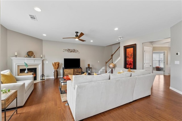 506 Spring View Dr, Woodstock, GA 30188 - living room featuring stairway, ceiling fan, a fireplace with flush hearth, wood finished floors, and recessed lighting