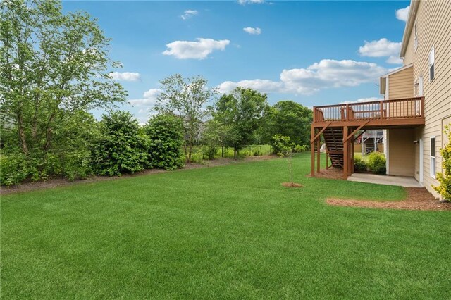 506 Spring View Dr, Woodstock, GA 30188 - view of green lawn with stairway and a wooden deck