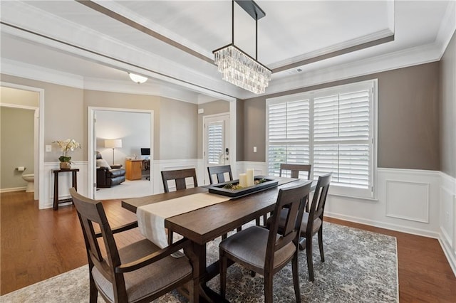 506 Spring View Dr, Woodstock, GA 30188 - dining area featuring a wainscoted wall, dark wood finished floors, a chandelier, crown molding, and a tray ceiling