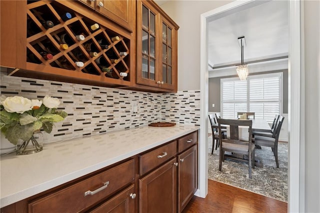 506 Spring View Dr, Woodstock, GA 30188 - kitchen featuring light countertops, dark wood-type flooring, glass insert cabinets, and decorative backsplash