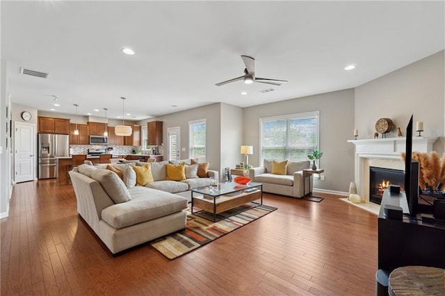 506 Spring View Dr, Woodstock, GA 30188 - living area with dark wood-type flooring, a fireplace with flush hearth, ceiling fan, and recessed lighting