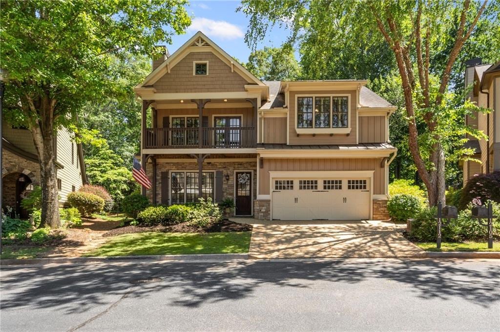 12112 Walnut Ter, Alpharetta, GA 30004 - craftsman house with a balcony, board and batten siding, concrete driveway, an attached garage, and stone siding