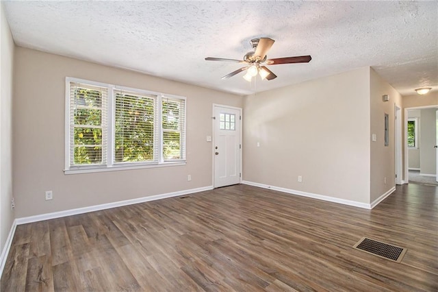 1829 Goddard St SE, Atlanta, GA 30315 - foyer entrance with a textured ceiling, a ceiling fan, healthy amount of natural light, and dark wood-type flooring