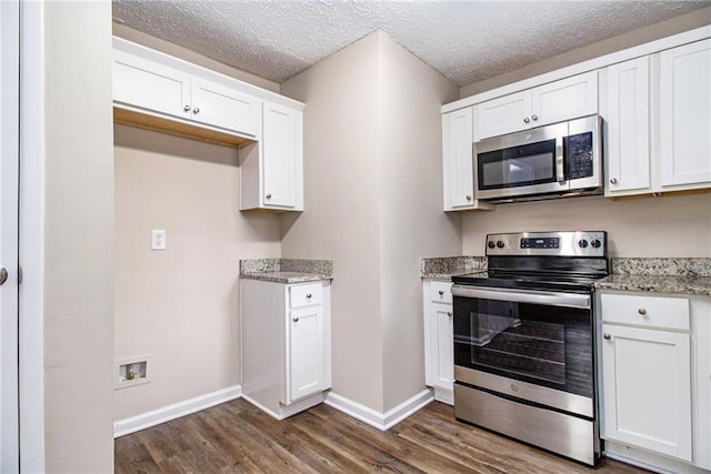 1829 Goddard St SE, Atlanta, GA 30315 - kitchen featuring stainless steel appliances, dark wood-type flooring, white cabinetry, light stone countertops, and a textured ceiling