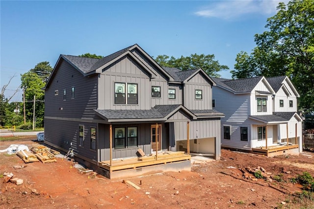 modern farmhouse featuring a porch, board and batten siding, and roof with shingles