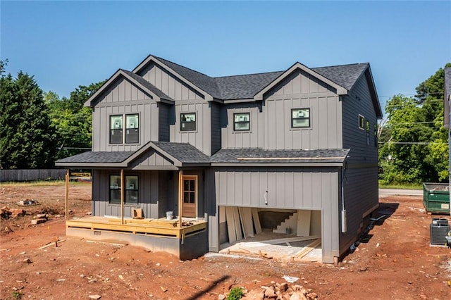 modern farmhouse with a porch, board and batten siding, and a shingled roof