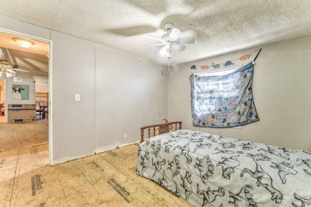 bedroom featuring a textured ceiling and a ceiling fan