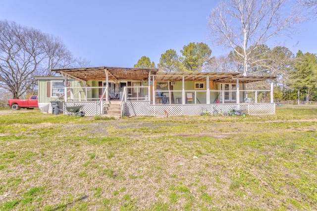 rear view of house with a yard