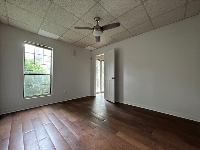 spare room featuring ceiling fan and dark wood-type flooring