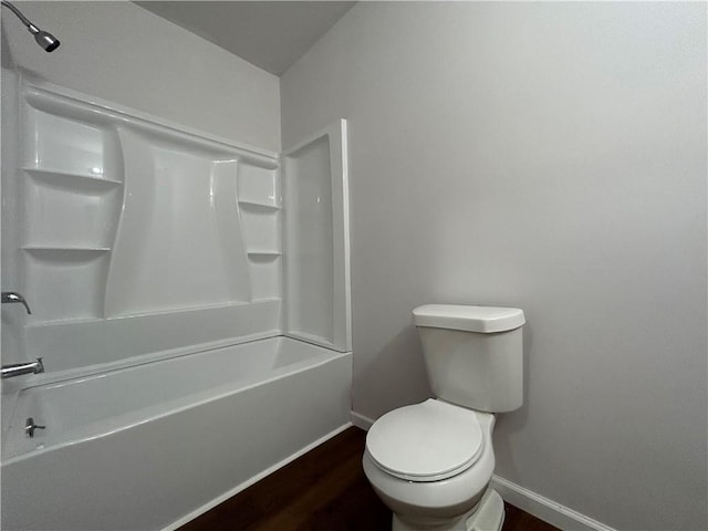 bathroom featuring hardwood / wood-style floors, bathtub / shower combination, and toilet