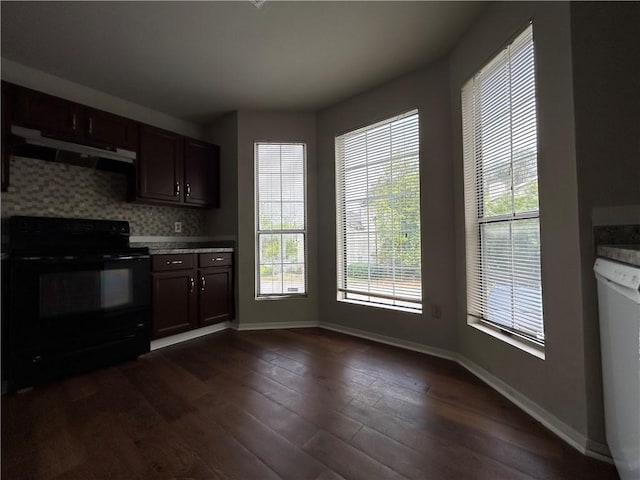 kitchen with dark brown cabinetry, dishwasher, tasteful backsplash, black electric range oven, and range hood