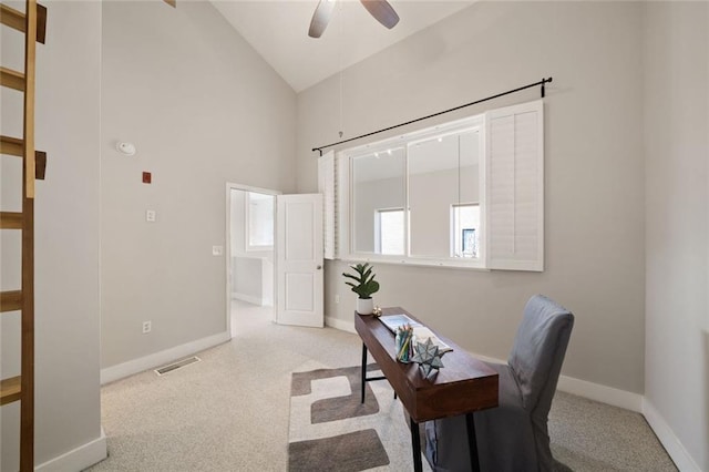 carpeted home office with visible vents, baseboards, high vaulted ceiling, and a ceiling fan