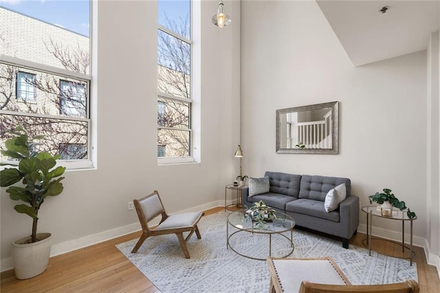 living area featuring wood finished floors and baseboards