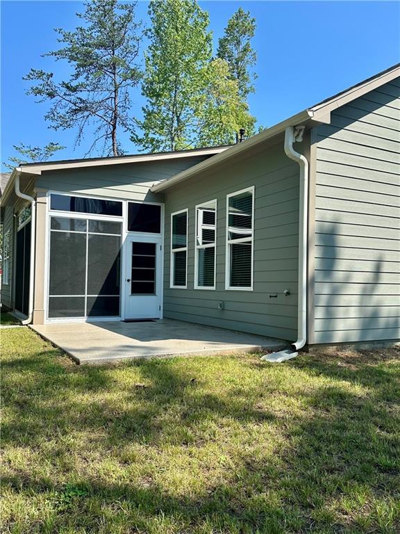 619 Linger Longer Dr, Ellijay, GA 30540 - back of house with a patio, a yard, and a sunroom