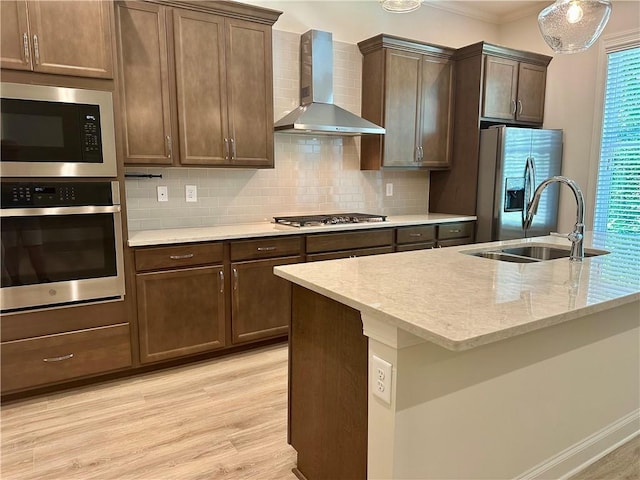 619 Linger Longer Dr, Ellijay, GA 30540 - kitchen with stainless steel appliances, wall chimney range hood, light wood-type flooring, backsplash, and light stone counters