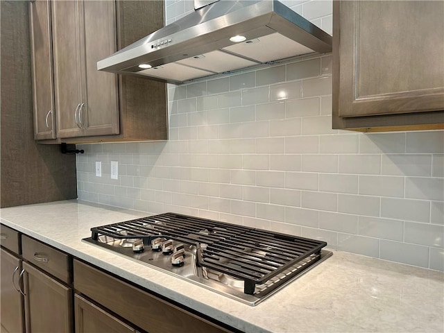 619 Linger Longer Dr, Ellijay, GA 30540 - kitchen featuring wall chimney range hood, stainless steel gas cooktop, light countertops, and tasteful backsplash