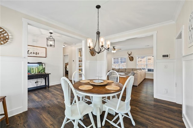 dining area featuring a chandelier, a decorative wall, ornamental molding, wainscoting, and dark wood finished floors