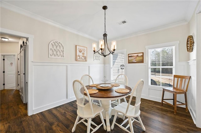 dining room with a barn door, dark wood finished floors, visible vents, and a healthy amount of sunlight