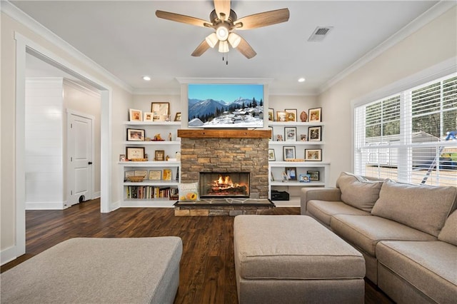 living area with a stone fireplace, ornamental molding, wood finished floors, and visible vents