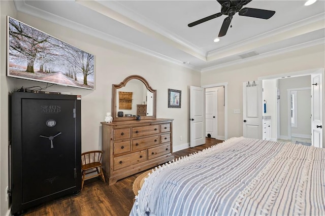 bedroom with recessed lighting, dark wood finished floors, baseboards, a raised ceiling, and crown molding