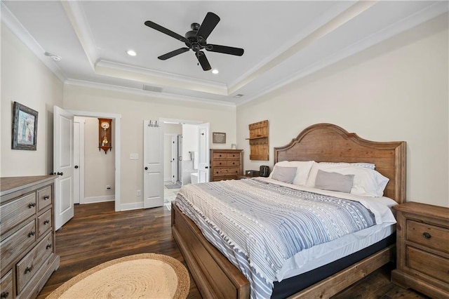 bedroom featuring recessed lighting, baseboards, ornamental molding, dark wood-style floors, and a tray ceiling