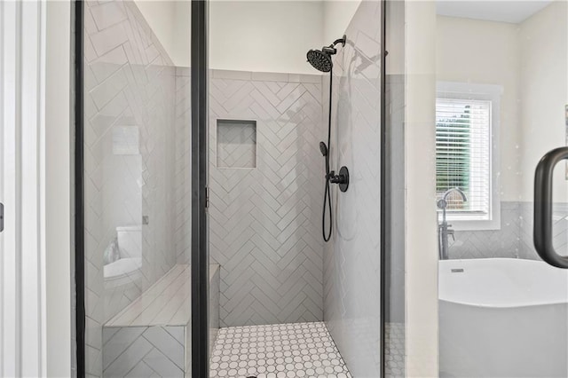 full bathroom with a freestanding bath and a stall shower