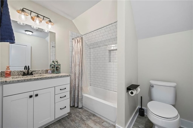 full bathroom featuring shower / bath combo, baseboards, toilet, lofted ceiling, and vanity