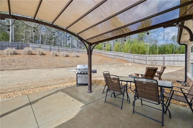 view of patio / terrace featuring a fenced backyard, area for grilling, and outdoor dining space