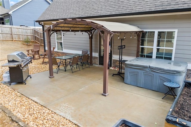 view of patio with a hot tub, grilling area, fence, a pergola, and outdoor dining space