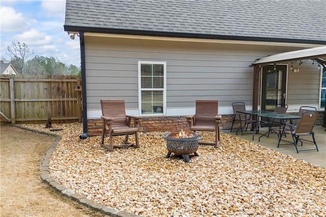 view of patio / terrace with an outdoor fire pit and fence