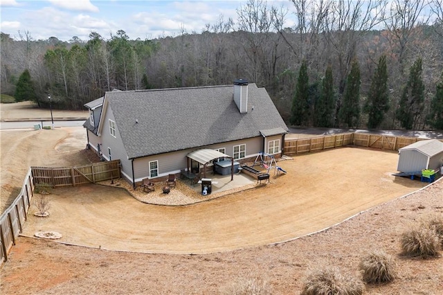 aerial view featuring a wooded view