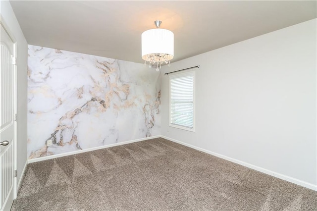 626 Discovery Ct, Acworth, GA 30102 - carpeted spare room with an inviting chandelier and baseboards
