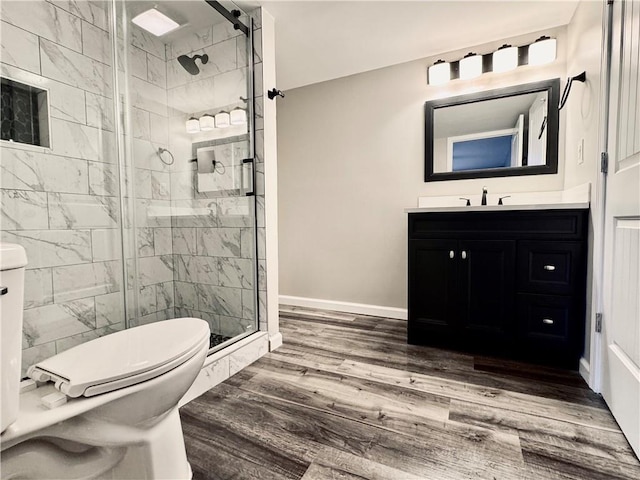 626 Discovery Ct, Acworth, GA 30102 - full bathroom with a shower stall, wood finished floors, vanity, baseboards, and toilet