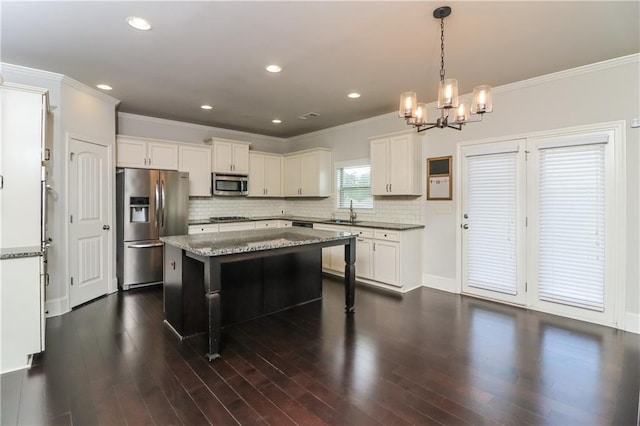626 Discovery Ct, Acworth, GA 30102 - kitchen with ornamental molding, a sink, appliances with stainless steel finishes, and a chandelier