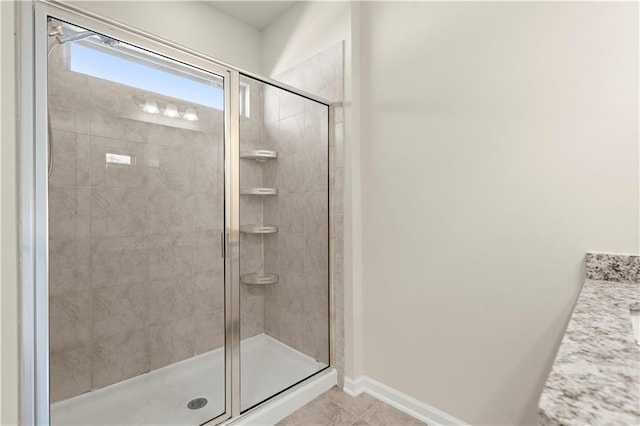 bathroom featuring an enclosed shower, vanity, and tile patterned floors