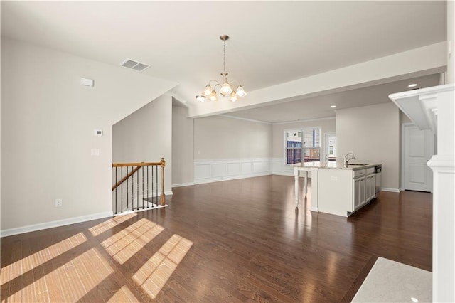 interior space with sink, a notable chandelier, and dark hardwood / wood-style flooring