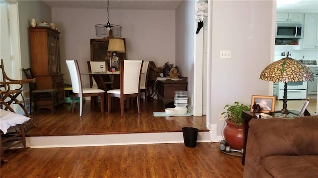 dining space with dark hardwood / wood-style flooring