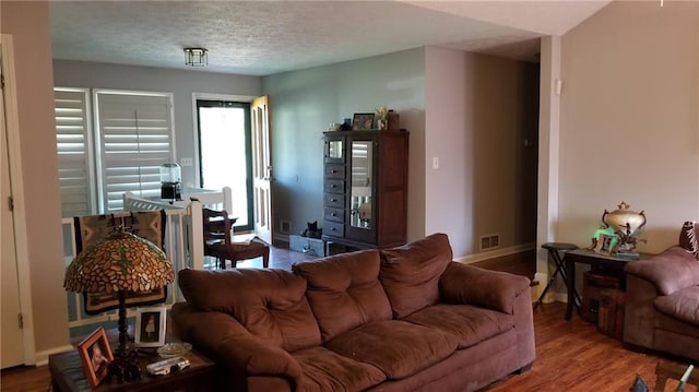 living room with hardwood / wood-style flooring and a textured ceiling