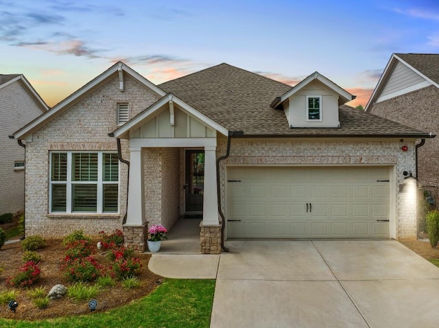 209 Floral Valley Dr, Woodstock, GA 30188 - view of front of home with an attached garage, a shingled roof, driveway, brick siding, and board and batten siding
