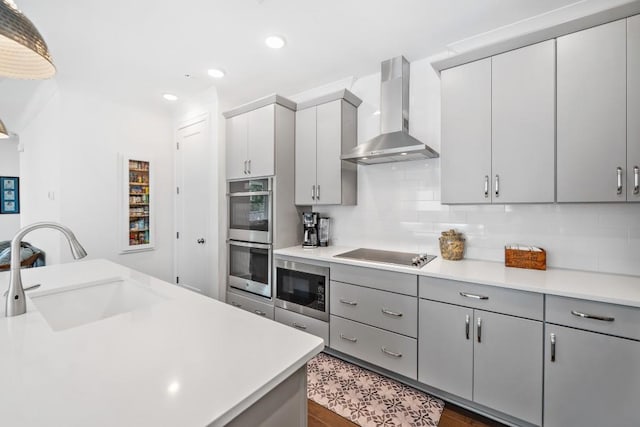 209 Floral Valley Dr, Woodstock, GA 30188 - kitchen featuring wall chimney exhaust hood, appliances with stainless steel finishes, a sink, light countertops, and decorative backsplash