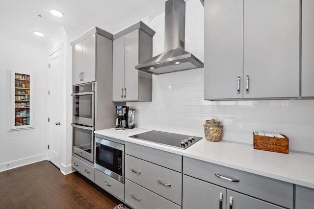 209 Floral Valley Dr, Woodstock, GA 30188 - kitchen with wall chimney range hood, appliances with stainless steel finishes, gray cabinets, baseboards, and dark wood finished floors
