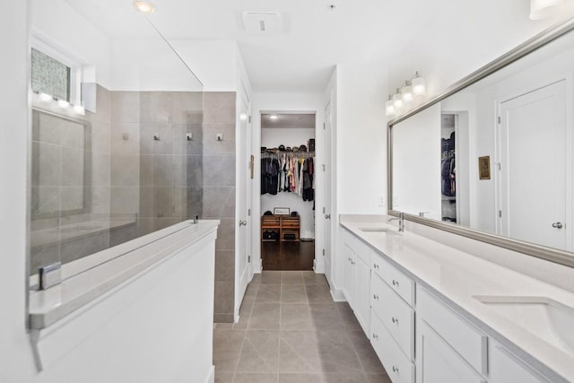 209 Floral Valley Dr, Woodstock, GA 30188 - bathroom with double vanity, a spacious closet, a walk in shower, and tile patterned floors