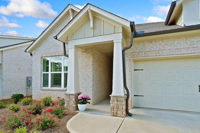 209 Floral Valley Dr, Woodstock, GA 30188 - property entrance with board and batten siding, an attached garage, brick siding, and driveway