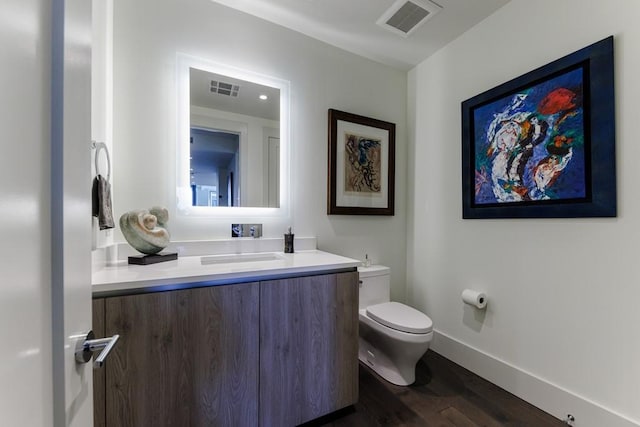 bathroom featuring hardwood / wood-style floors, vanity, and toilet