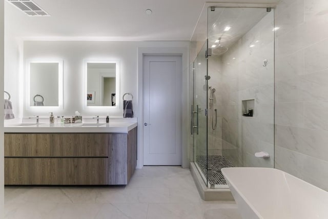 bathroom featuring vanity and separate shower and tub