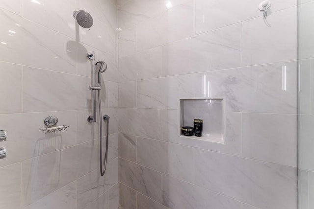 bathroom with a tile shower