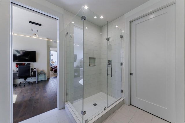 bathroom with tile patterned flooring and an enclosed shower