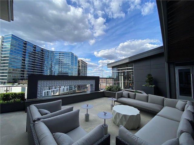 view of patio / terrace with a balcony and an outdoor hangout area