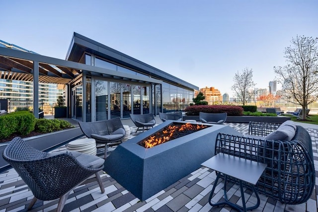 view of patio featuring an outdoor living space with a fire pit